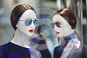 Mannequins standing in store window display