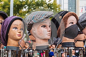 Mannequins wearing hats on the sidewalk in Harlem