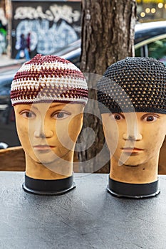 Mannequins wearing kufi skull caps on the street in Harlem