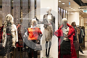 Mannequins in the window of a clothing store. Demonstration of the new collection