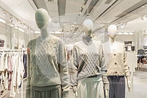 Mannequins in the window of a clothing store. Demonstration of the new collection
