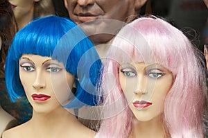 Mannikin heads with colorful wigs in wig store