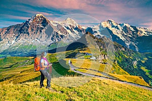 Mannlichen tourist station with backpacker hiker woman, Grindelwald, Switzerland, Europe
