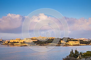 Manoel Island at sunrise with fishing boat and beautiful clouds