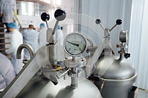 Manometer on the cylinder with gas in modern brewery. Close-up view