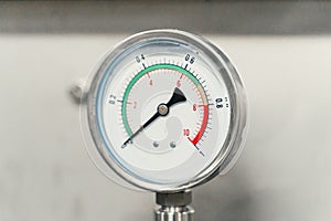 Manometer or pressure gauge on factory equipment close up