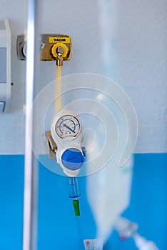 Manometer with reducer for breathing control, help with medical equipment. The oxygen reducer is mounted on the wall with an
