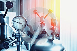 Manometer on steel tank in modern brewery factory, toned, abstract industrial background