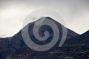 Manquehue mountain on a foggy day in Santiago, Chile