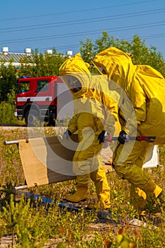 Mans with briefcase in protective hazmat suit