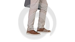 Mans feet is walking in jeans and sneakers on white background.