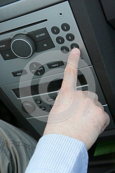 Mans hand and car radio