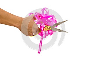 Mans hand cutting something with scissors and pink bow isolated