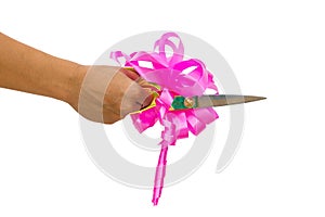 Mans hand cutting something with scissors and pink bow isolated