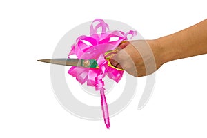 Mans hand cutting something with scissors and pink bow isolated