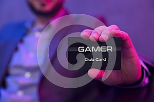 Mans hand holds gamer clubcard