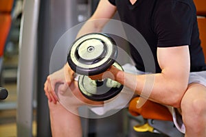 Mans hand, raising and lowering dumbbell in