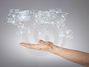 Mans hand showing world map