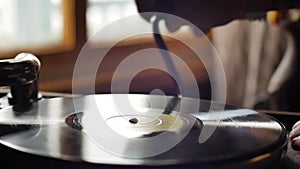 Mans hand turning the handle of the old retro gramophone close-up slow motion shot