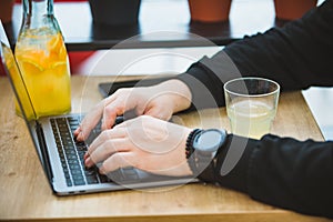 mans hands on laptop keyboard freelance concept