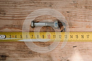Mans hands working with wood measuring tape photo