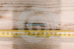 Mans hands working with wood measuring tape photo