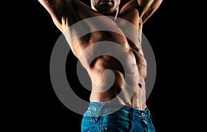 Mans torso. Sexy and naked muscular young man posing on the studio.