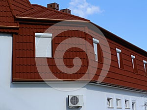 Mansard roof exterior detail with brown clay tile roof covering