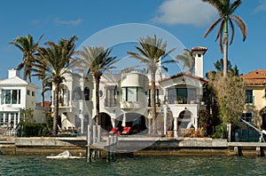 Mansion with chairs and palms