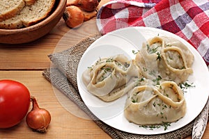 Manti dumpling on white plate.