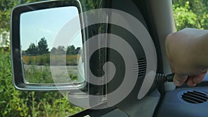 Manual adjustment of the side mirrors of the car. Adjusting car mirrors before a ride