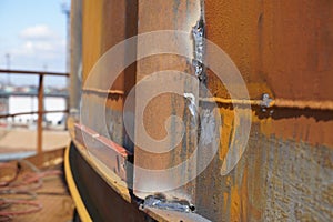 Manual arc welding. Defective butt weld of welding of metal sheets. Repair of a tank for storing oil, gasoline and gas