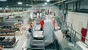 Manual assembly of fridges carried out by factory workers