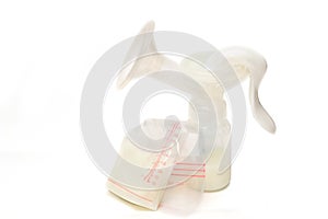 Manual breast pump and bags of breastmilk