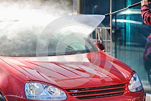 Manual car wash with pressurized water in car wash outside.Summe Washing. Cleaning Car Using High Pressure Water.