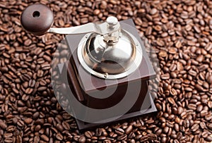 Manual coffee grinder on a background of coffee beans