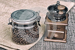 Manual coffee grinder with coffee beans.