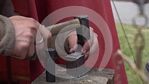 Manual coinage. coinage in the anvil. Ancient Russia art. A man is minting coins with a hammer.