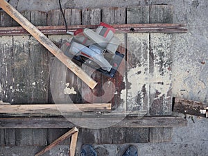 Manual electric plane on raw tree log