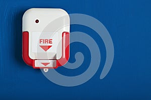 Manual fire alarm pull station on wall indoors