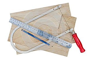 Manual fret saw and plywood isolated