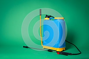 Manual insecticide sprayer on green background, space for text. Pest control