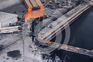 Manual jackhammer in a reinforced concrete panel