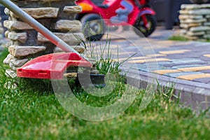 Manual lawn mower on the background of green grass