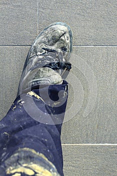 Manual man worker old shoes detail high view