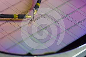 Manual probe system with needles for test of semiconductor on silicon wafer. Selective focus.