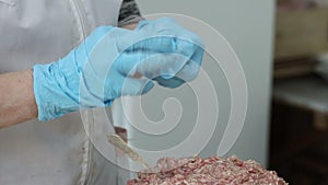 manual production of dumplings at a food factory from dough and minced meat