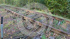 Manual railway arrow on rusty rail track