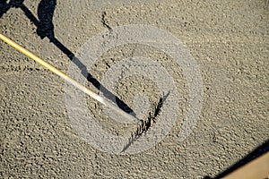 Rake spreading the liquid concrete photo