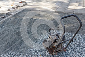 Manual ramming machine for compacting soil at a construction site. Equipment for construction work. Hand tool